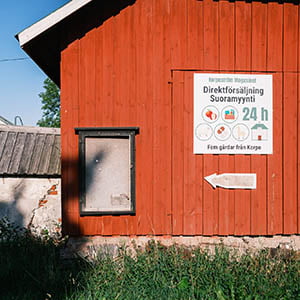A red barn with a sign in front.